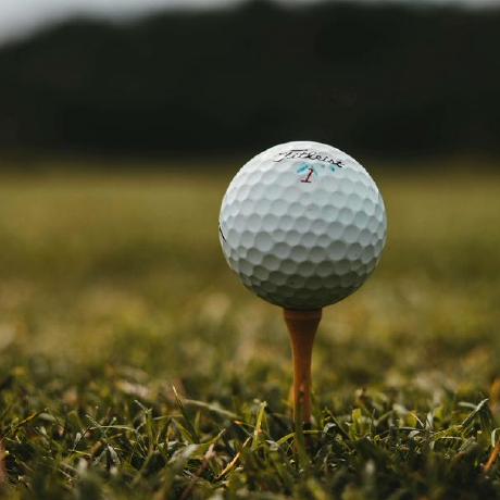 Golf ball on a tee on the course